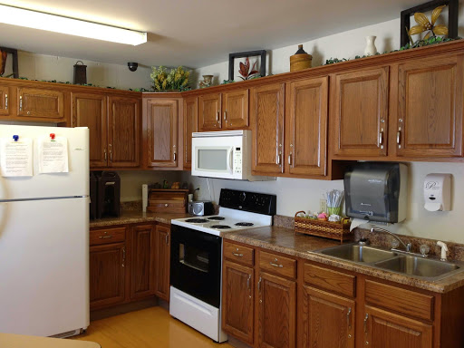 A cozy kitchen featuring wooden cabinets and essential appliances.