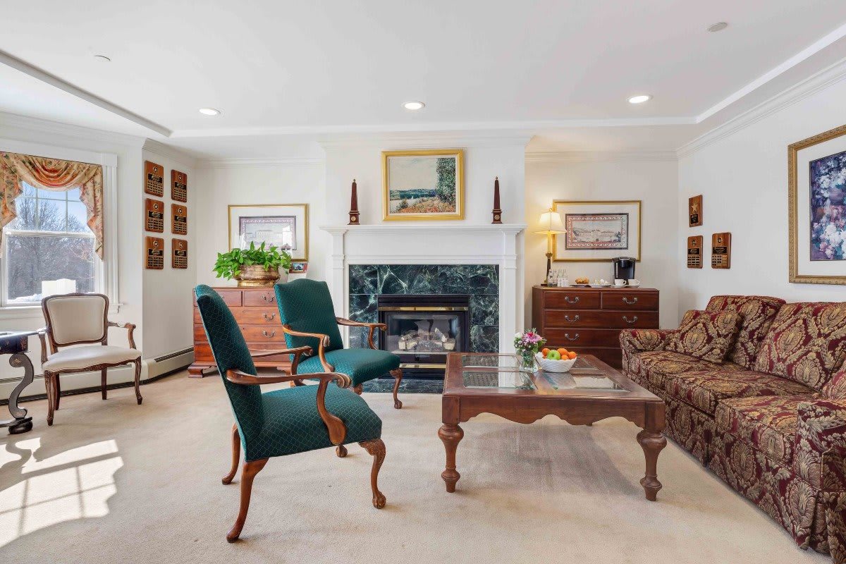 A well-decorated living room with elegant furniture and a cozy fireplace.