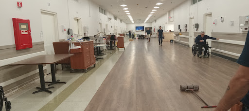 A spacious interior of a hospital facility with medical equipment and staff.