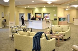 A modern lobby with comfortable seating and a reception desk.