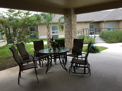 A cozy outdoor patio area with a table and chairs, perfect for relaxation.