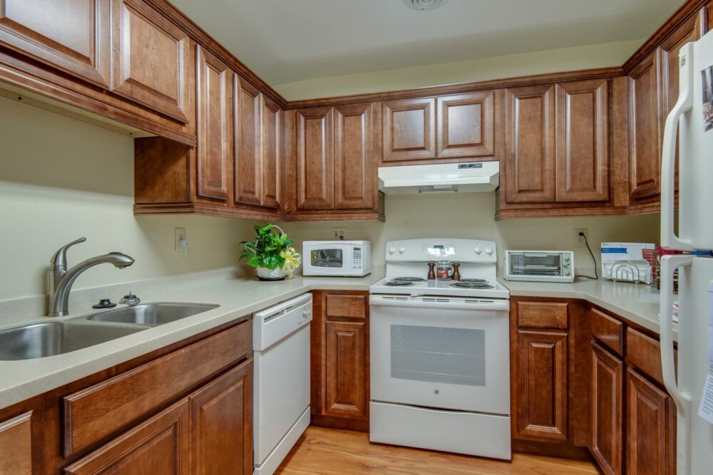 A cozy kitchen with wooden cabinets and modern appliances.