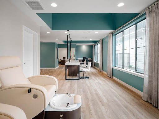 A modern and inviting nail salon featuring spacious interiors, soothing colors, and ample natural light.