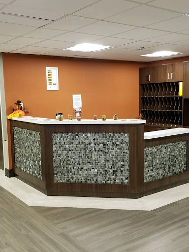 A modern reception area featuring a stylish desk with unique stone detailing.