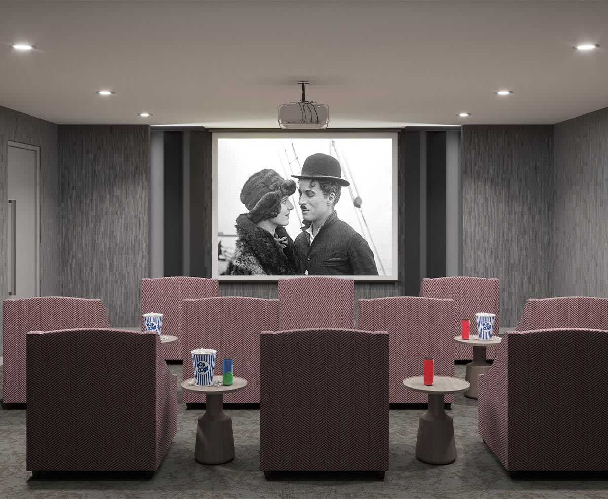 A cozy home theater setup showcasing a classic black and white movie on the projector screen.