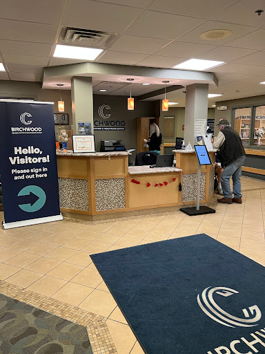 A welcoming reception area with a visitor sign and a registration desk.