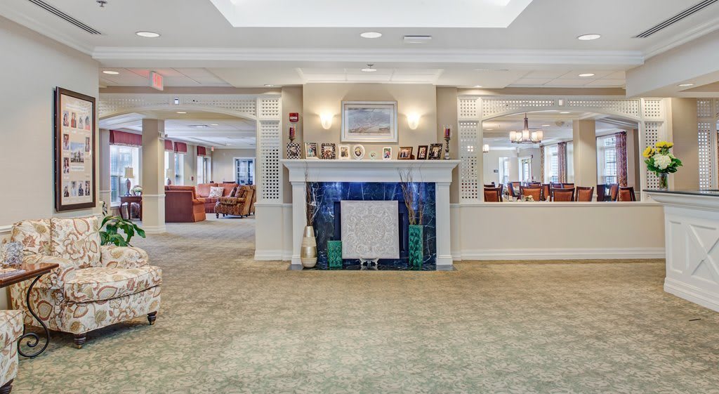 A cozy living room area with a central fireplace and comfortable furnishings.