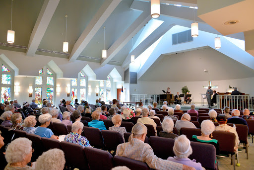 A serene gathering of seniors attending a service at a church.