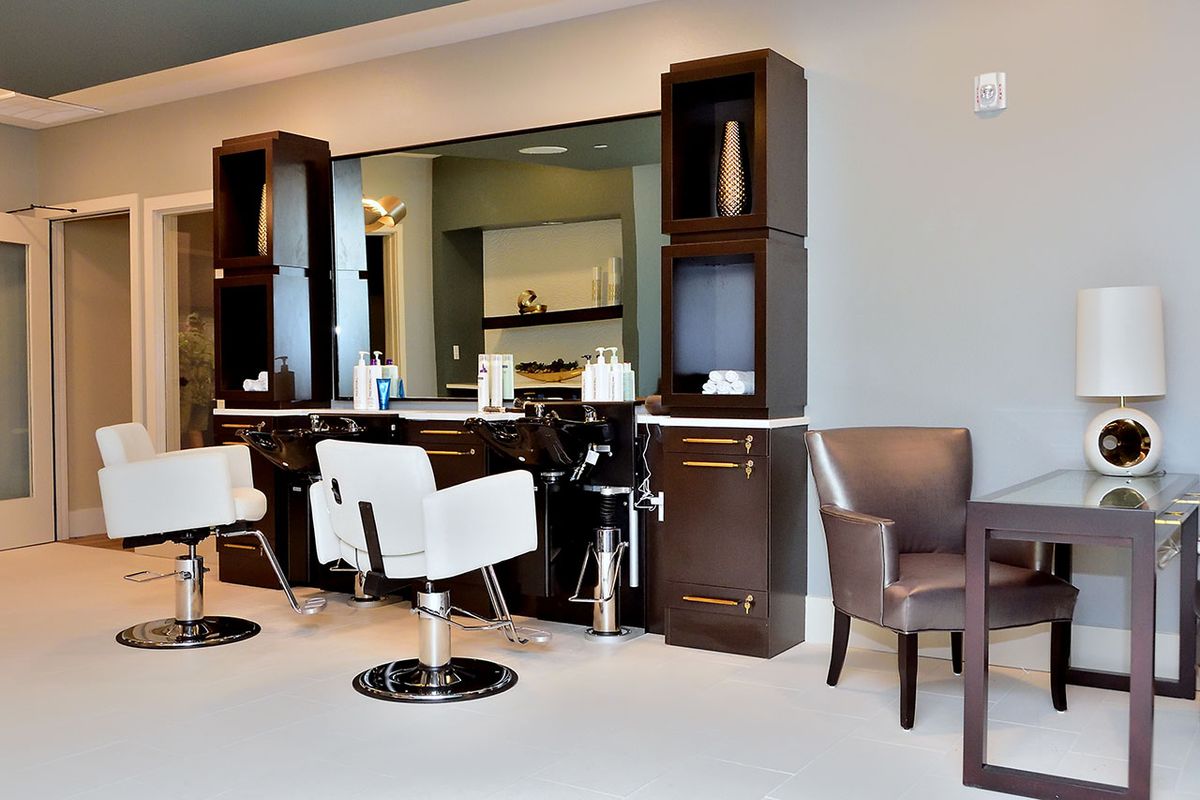 Modern salon interior with styling chairs and mirrors.