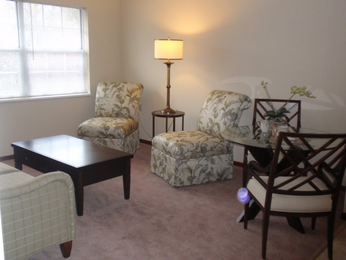 A cozy living room with patterned chairs and a coffee table.