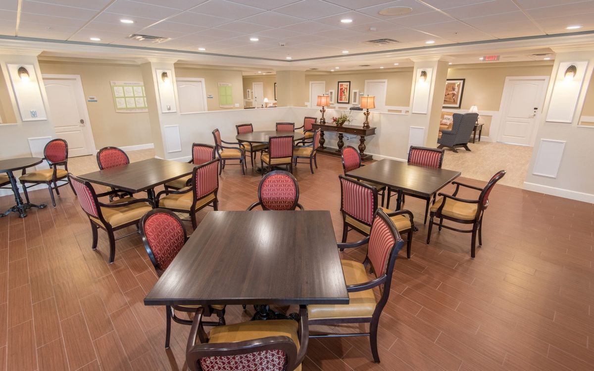 A spacious dining area with several tables and chairs arranged neatly.