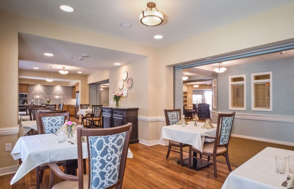 A well-decorated dining room with elegant tables and chairs.