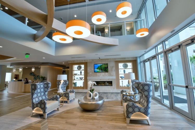 A modern and spacious lounge area featuring contemporary furniture and unique lighting fixtures.