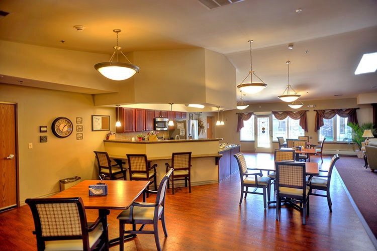 A cozy dining area with arranged tables and warm lighting.
