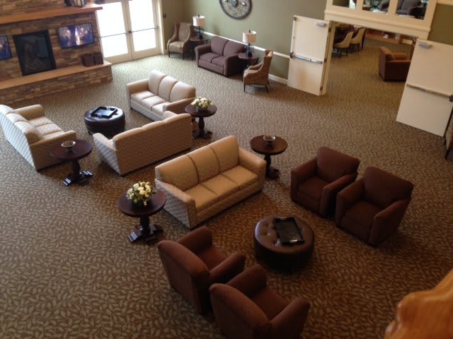 A cozy lobby area with sofas, chairs, and tables arranged for comfort.