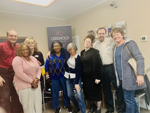 A diverse group of individuals gathered for a meeting, showcasing collaboration and community.