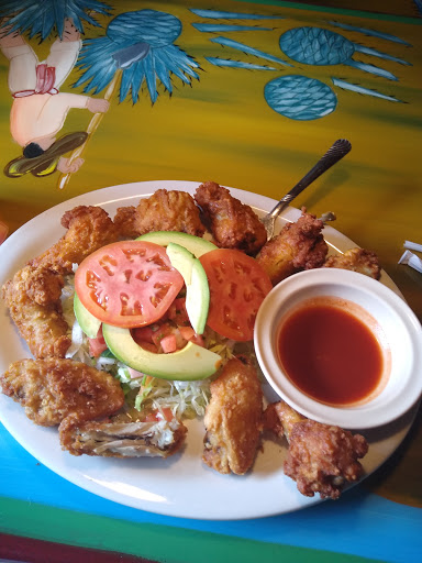 A delicious plate of fried chicken served with fresh vegetables and dipping sauce.