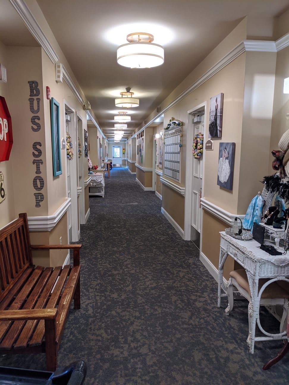 A decorated hallway with benches and various signs along the walls.