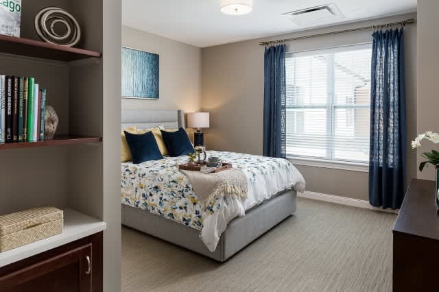 A modern and comfortable bedroom with stylish decor and ample natural light.