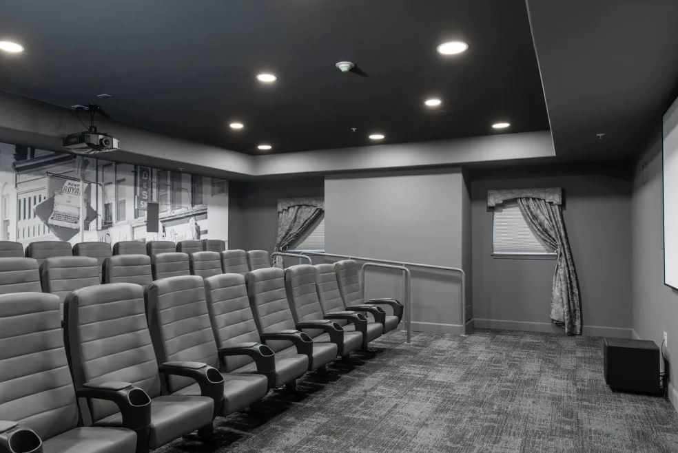 An empty theater with rows of comfortable seating.