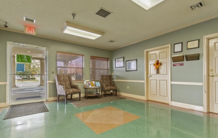 A cozy waiting room with chairs and decor.