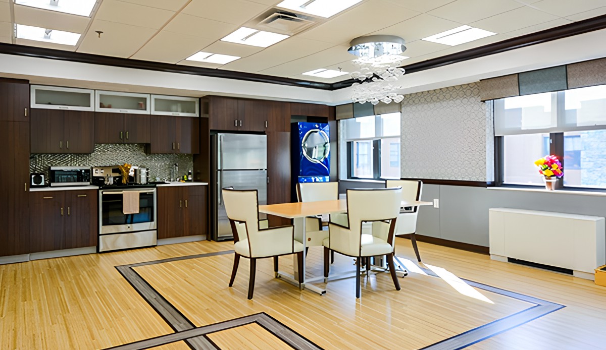 A modern kitchen and dining area with sleek furnishings and appliances.