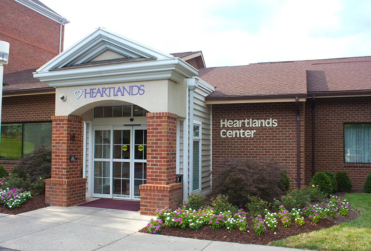 A brick building labeled 'Heartlands Center' with a landscaped entrance.