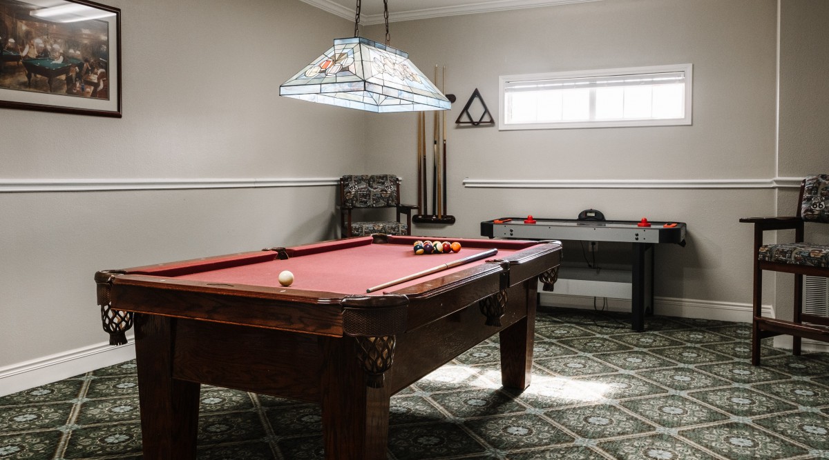 A game room featuring a pool table and air hockey table.