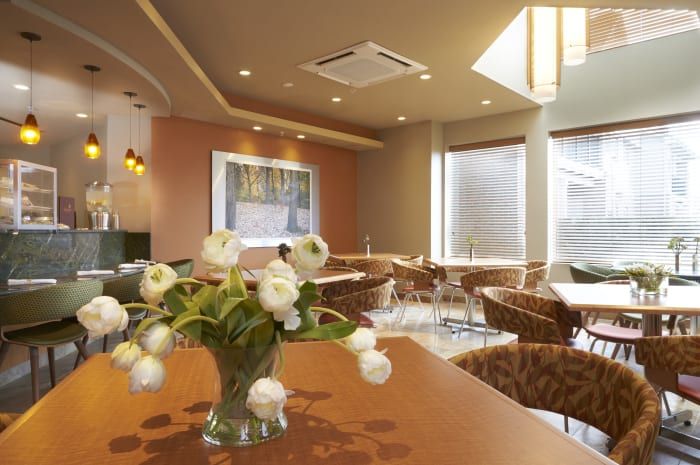 A cozy restaurant interior with elegant floral decor and soft lighting.