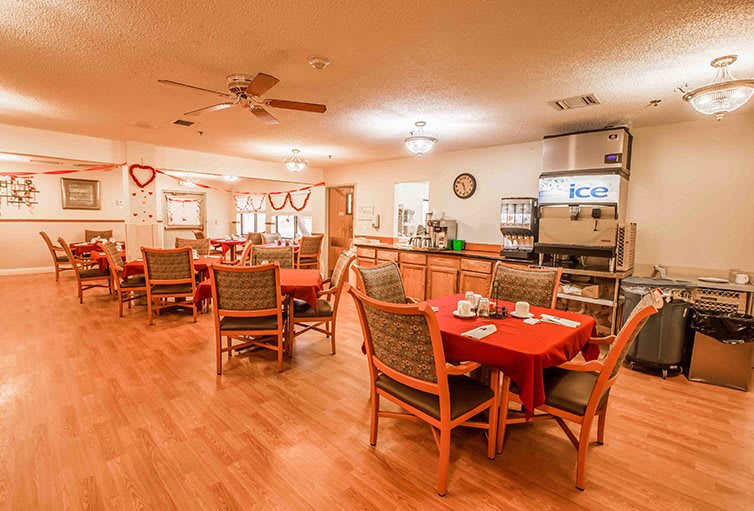 An empty dining area with decorated tables and chairs.