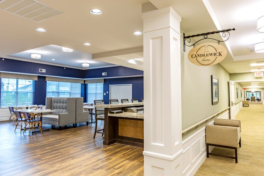 A modern dining area with elegant furnishings and warm lighting.