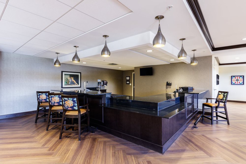 A modern cafe interior with a sleek counter and stylish seating area.