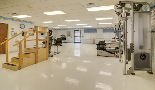 A spacious and clean medical treatment room equipped with various healthcare instruments.