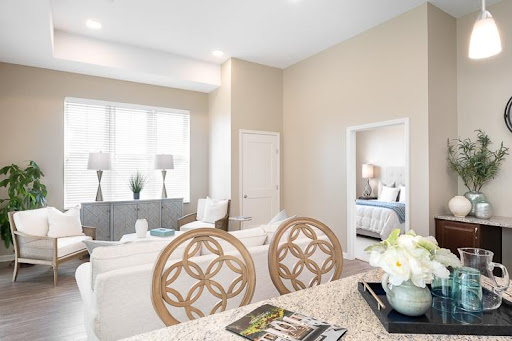 A beautifully designed modern living room with a light color palette and stylish furnishings.
