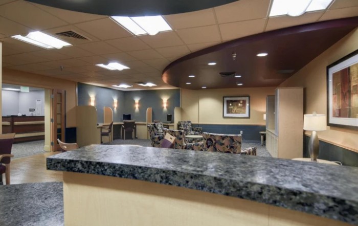 A modern reception area with seating and lighting fixtures.