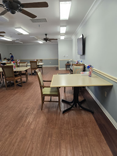 A spacious dining area featuring neatly arranged tables and chairs, designed for communal meals.