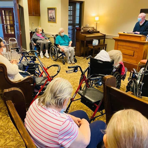 A group of seniors gathered for a presentation in a community space.