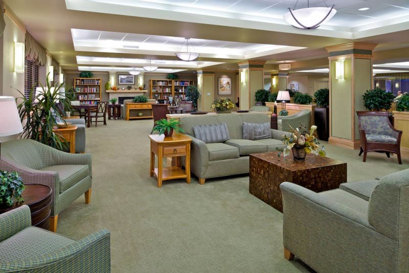 A spacious library interior with comfortable seating and bookshelves.