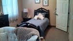 A cozy bedroom with a single bed and stylish decor.