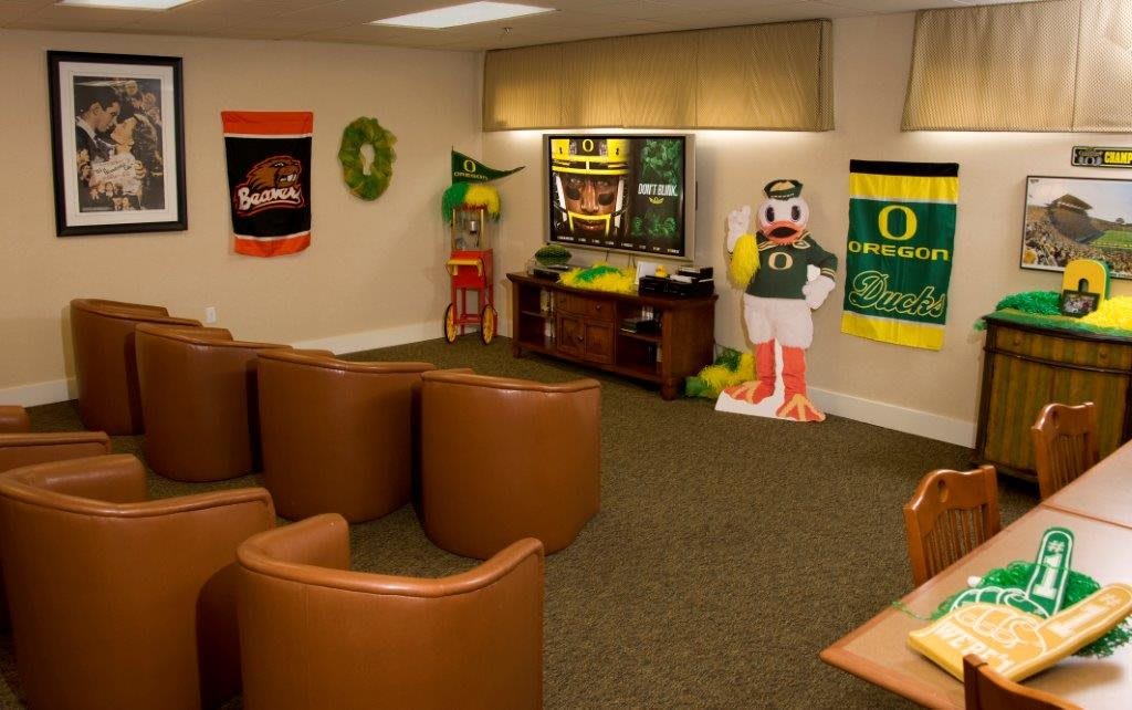A cozy game room featuring sports-themed decor and a university mascot display.