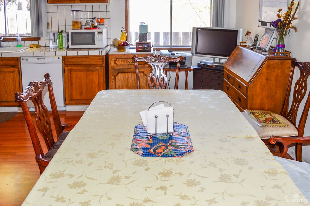A cozy kitchen with a dining table set for a meal.