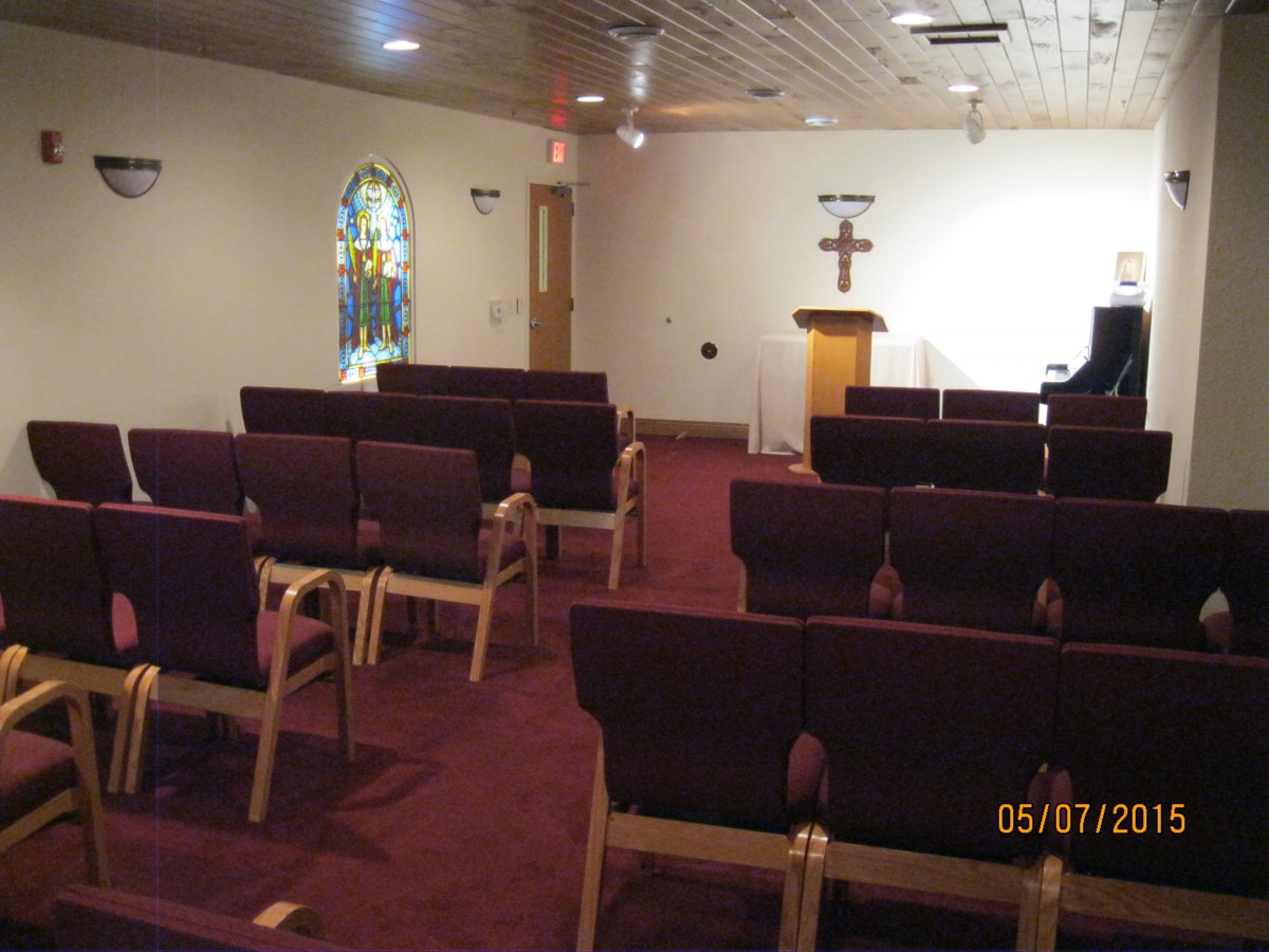 A church interior with rows of seating and a pulpit at the front.