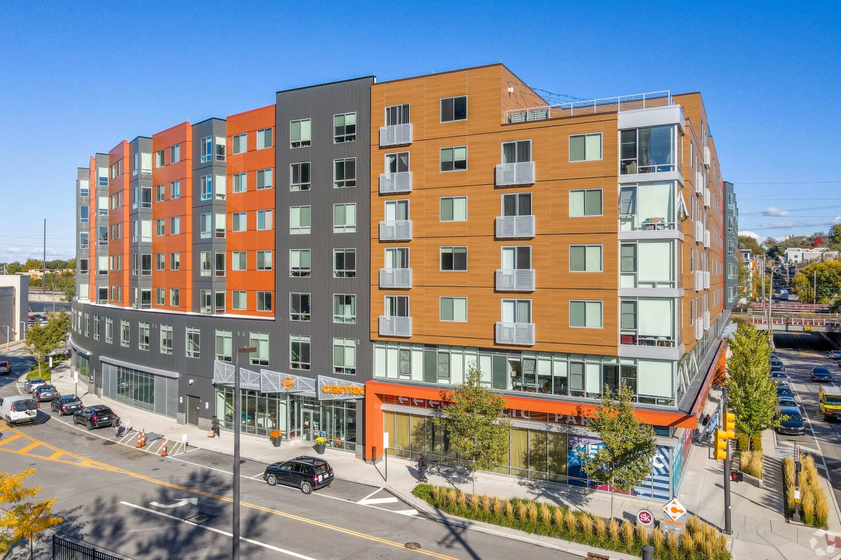 A modern multi-story apartment building in an urban residential area.