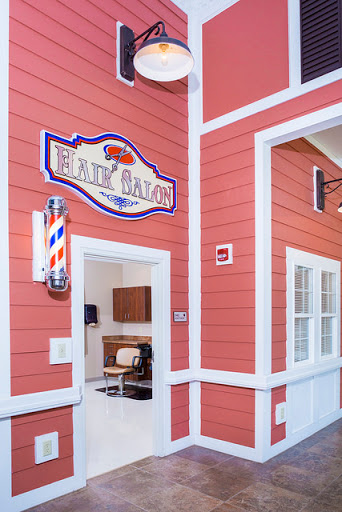 Entrance to a cozy barber shop featuring a classic barber pole and welcoming decor.