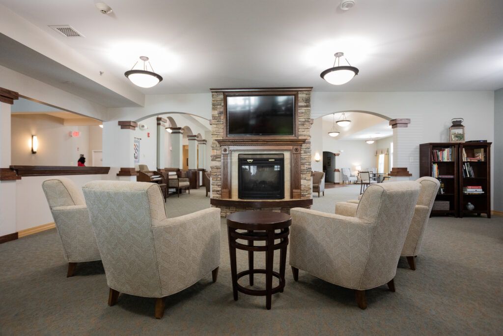 A modern lounge area with comfortable seating and a double-sided television setup.