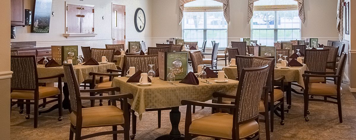 A well-arranged dining area with neatly set tables and chairs, showcasing elegant interior decor.