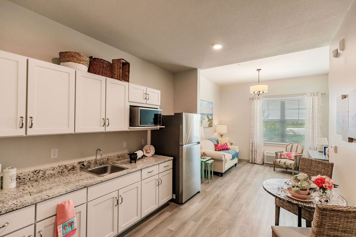 A modern, open-plan kitchen and living area with stylish furnishings and decor.