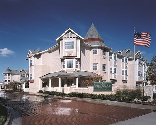 A view of a hotel building with an American flag flying outside.