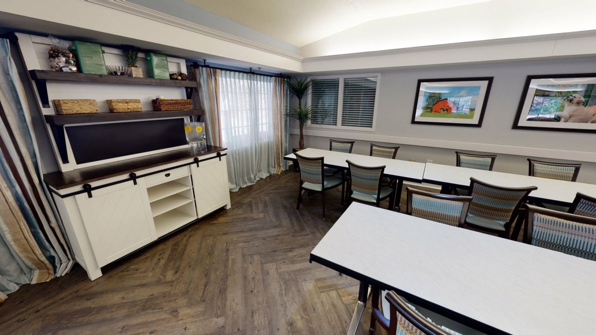 A meeting room with tables and chairs arranged for a conference.