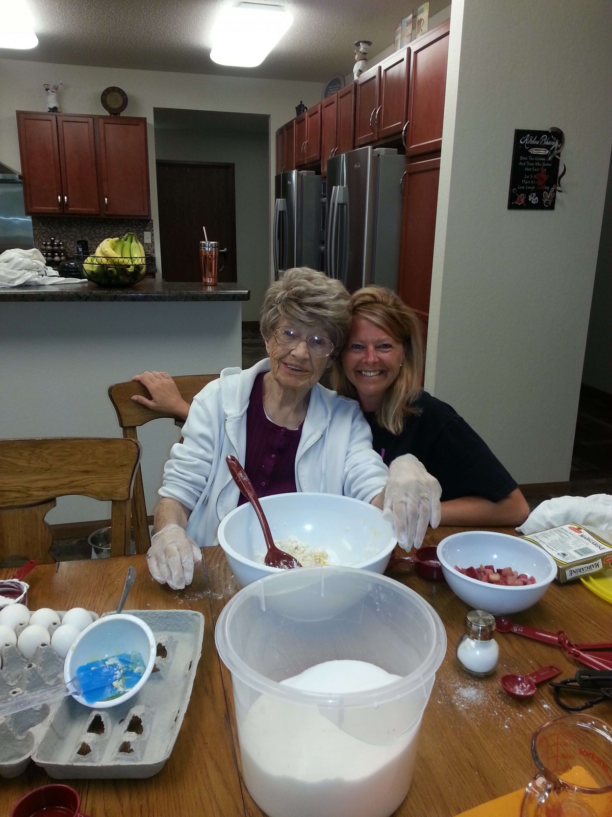 Two people enjoying baking together in the kitchen.